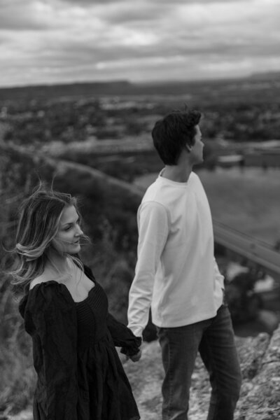Dramatic Angle Couple Holding Hands on Cliff Edge at Garvin Heights Overlook in Winona, MN