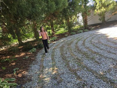 Young lady walking around the lanes of a labyrinth at Lavender Fields.