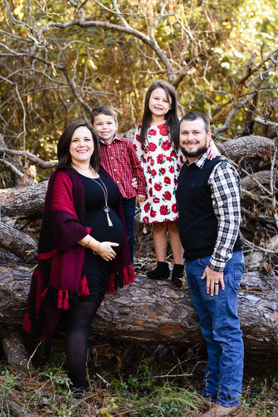 Beautiful Mississippi Family Photography: Couple and their children in winter clothing in the woods