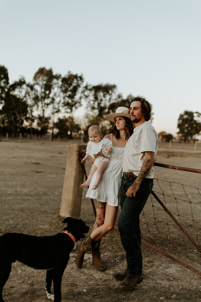 Young child jumping into a parent's arms during a family photoshoot, captured by Kayla Frizzell Photography