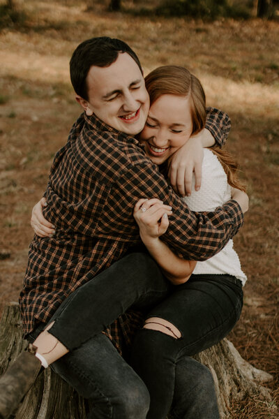 man and woman sitting hugging