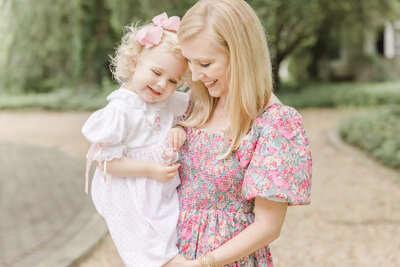 Mother snuggling toddler daughter in her arms -Family Photographer Greenville SC