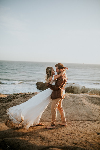 couple hugging by the ocean
