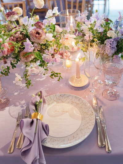 Pastel centerpiece on table with lilac napkins