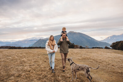 a family walking at Jason's Clearing during their sunset family photoshoot in Wanaka
