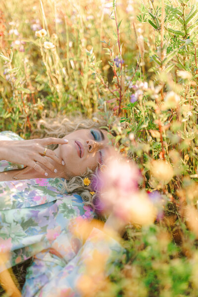 A fashion-forward portrait in golden light — pastel floral suit and lavender cat-eye sunglasses bringing vintage flair to desert glam. Greenville SC, Dani Lacey.