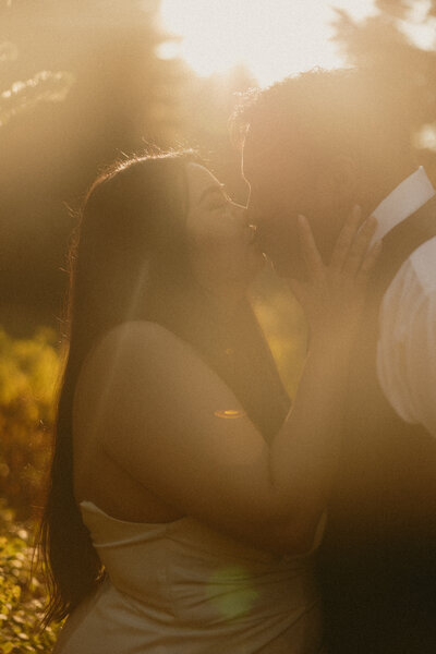 A couple kissing in the golden light at Mt. Rainier