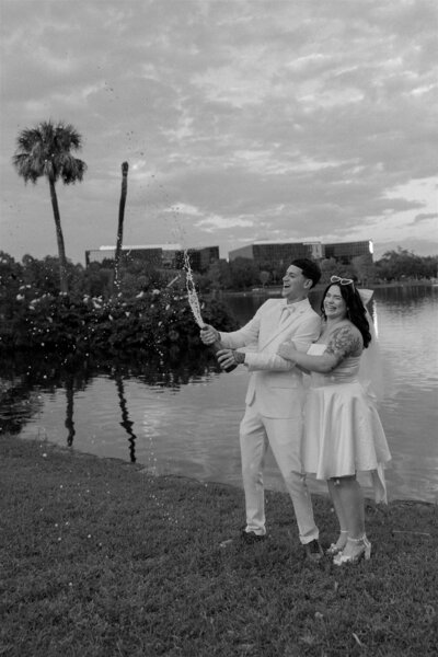 Bride and groom share a romantic kiss inside an elevator at the Orange County Courthouse during their intimate Orlando elopement, captured in timeless black and white.