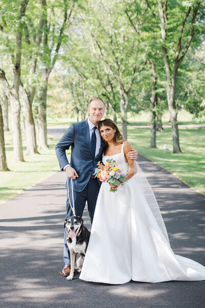 Bride and groom sharing a moment with their dog — full-service wedding planning in NJ