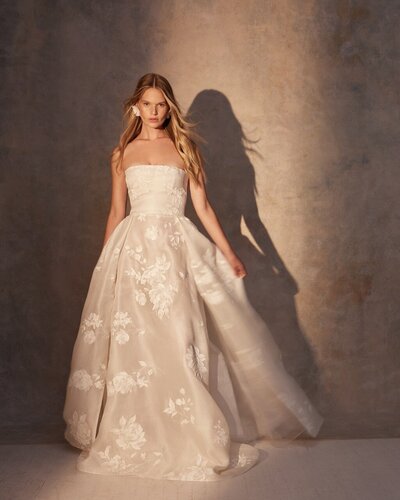black and white image bride wearing strapless satin wedding dress with long train