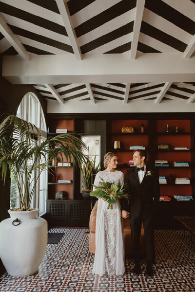 Bride and groom holding hands in