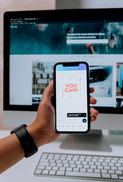 Professional using a smartphone and a desktop computer to handle one-time Google Ads setup, showcasing best practices in Google Ads management services.