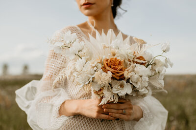 Boho inspired wedding bouquet with white and rust flowers, by Meadow & Vine Floral, romantic Alberta wedding florist, featured on the Brontë Bride Vendor Guide.