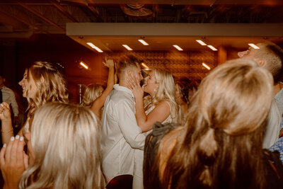 bride and groom kissing during dance