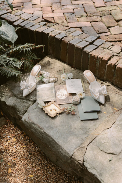Beautiful wedding day flatlay with brides jewelry and invitations.