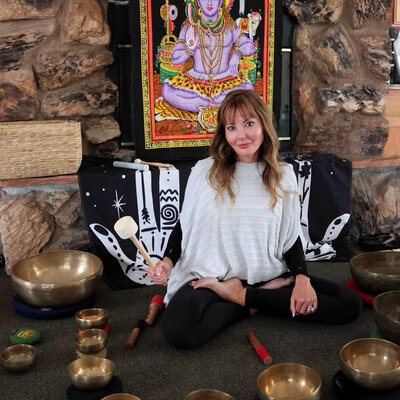 dana in front of tibetan sound bowls at a sound bath