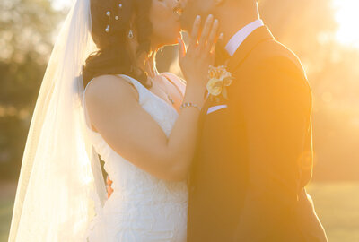 Sunset portrait of the bride and groom together for a photo.