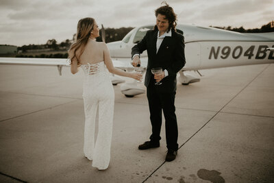 Engaged couple pouring some champagne during their engagement session in Jacksonville, Florida