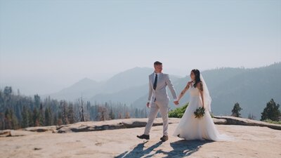 A couple holding hands during their wedding at Sequoia National Park in California.