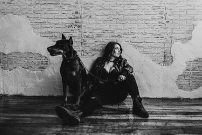 woman sitting next to her dog