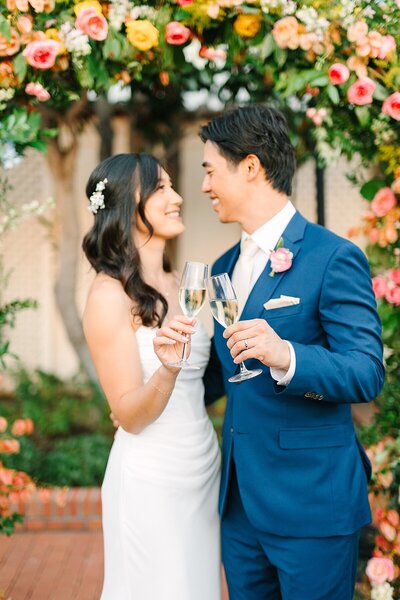 Married couple doing a champagne cheers at Darlington House in La Jolla, California.