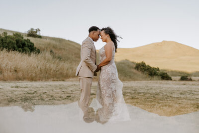 bride and groom embracing in desert