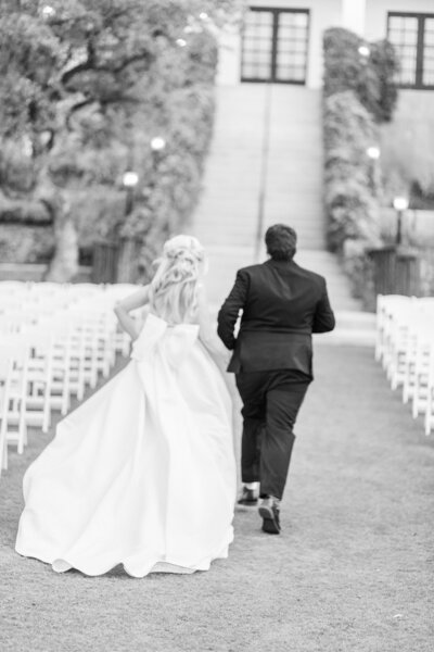 Bride and groom  running to Kendall Point wedding venue