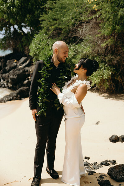 Multicultural ceremony under tropical florals at oceanfront Oahu venue