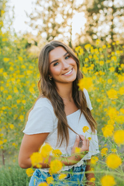 joyful senior girl in open landscape