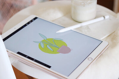Illustration of potted plant on iPad on small table with Apple pencil