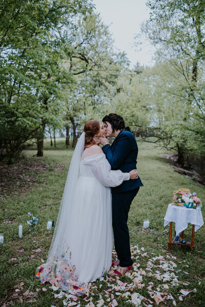 Minnesota Wedding Photographer captures brides kissing after garden wedding