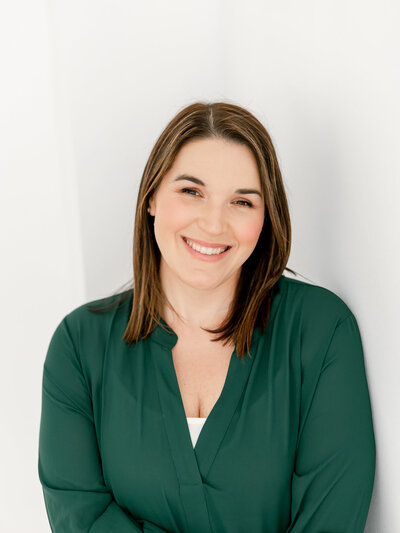 headshot image of woman in green blouse