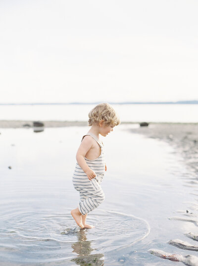 Toddler wading in water barefoot captured by Seattle Newborn and Maternity Photographer