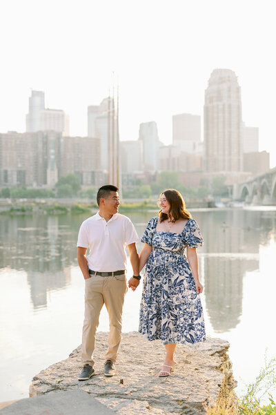 Engaged couple kissing in a park, taken by wedding photographers in minneapolis