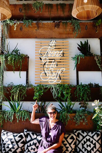 Photographer Danielle Elliott of Danielle Motif Photography under Treat Yo Self Sign at Base Coat Nail Salon in Los Angeles