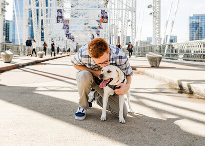 Boy posing with his dog on a bridge in downtown Nashville