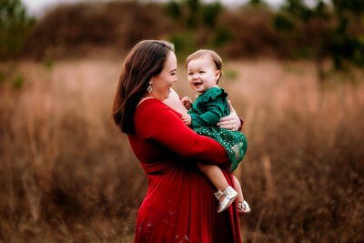 Pregnant mother holds her daughter during a maternity photoshoot near Birmingham