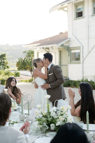 Bride and groom kissing at their La Jolla wedding reception.