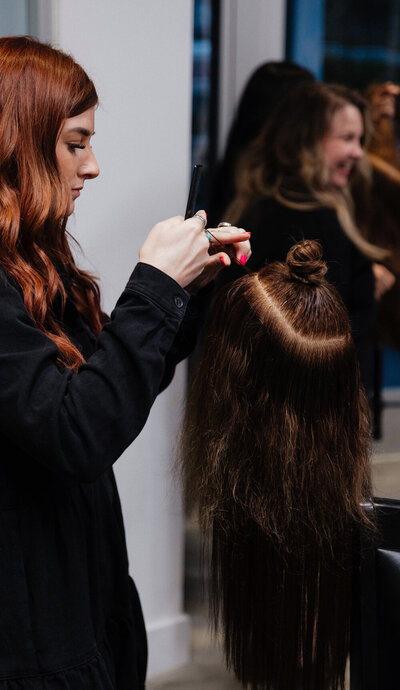 Student performing the NBR Hair Extension Method in Certification Course