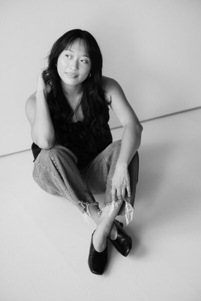 rachael shek sits on floor of studio for a portrait taken by boston documentary wedding photographer