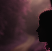 Silhouette in a dark scene representing the grief of late ADHD diagnosis