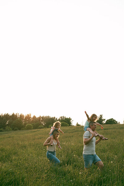 Family having fun in the park during their photo session in Ontario.