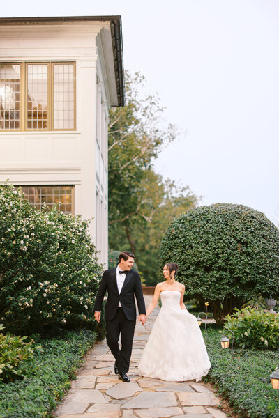 Bride walking with bouquet alongside a man