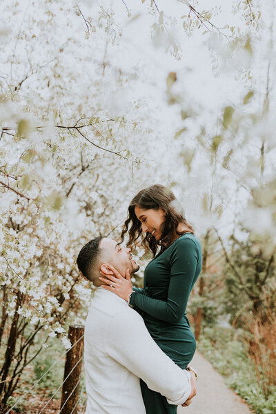 Guy carrying girl in almond blossom grove