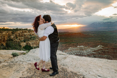 couple kissing at sunset during their elopement
