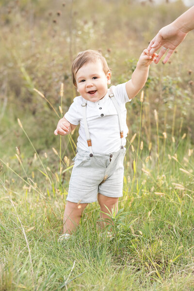 toddler standing in a field