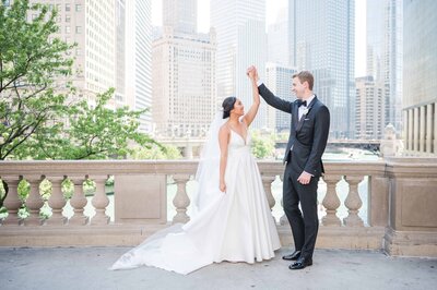 Bride and groom portrait of bride twirling in downtown Chicago.