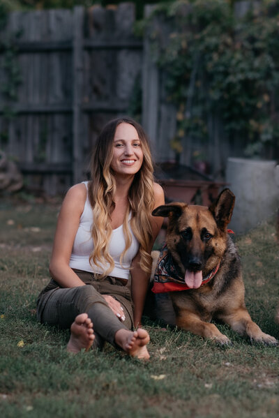 Photographer sitting in backyard with German Shepherd dog