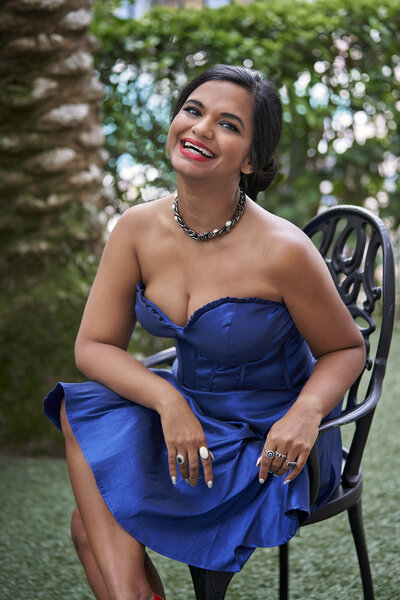 business woman in a blue dress sitting in the garden