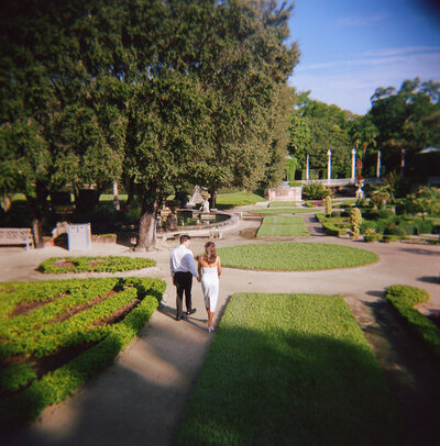 newlyweds walking down city sidewalk